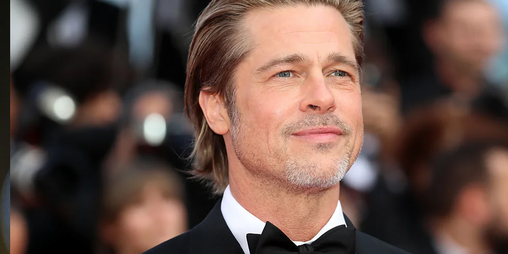 Brad Pitt at a film premiere, showcasing his classic style and charisma as a Hollywood icon